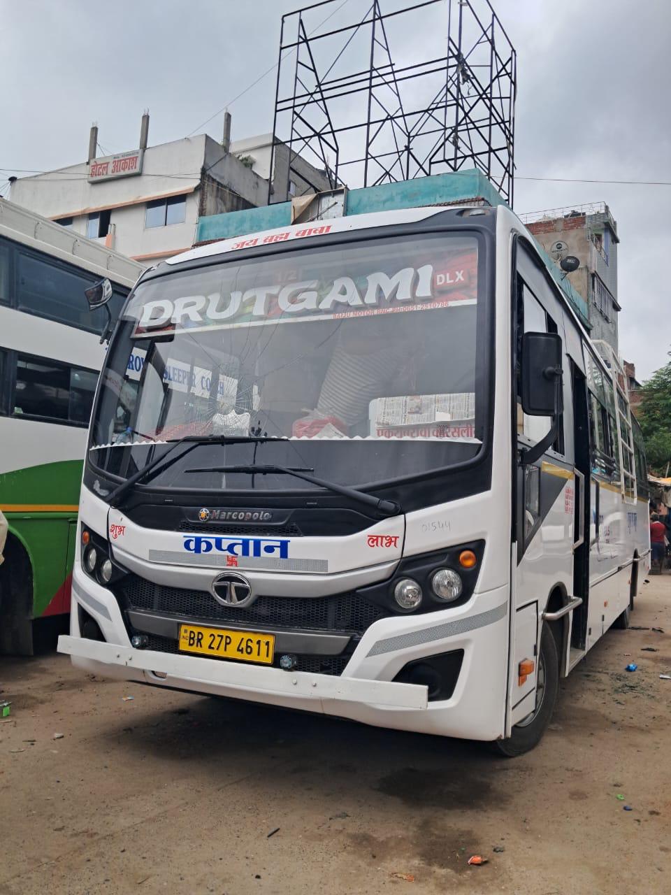 Drutgami Deluxe bus front angled near buildings