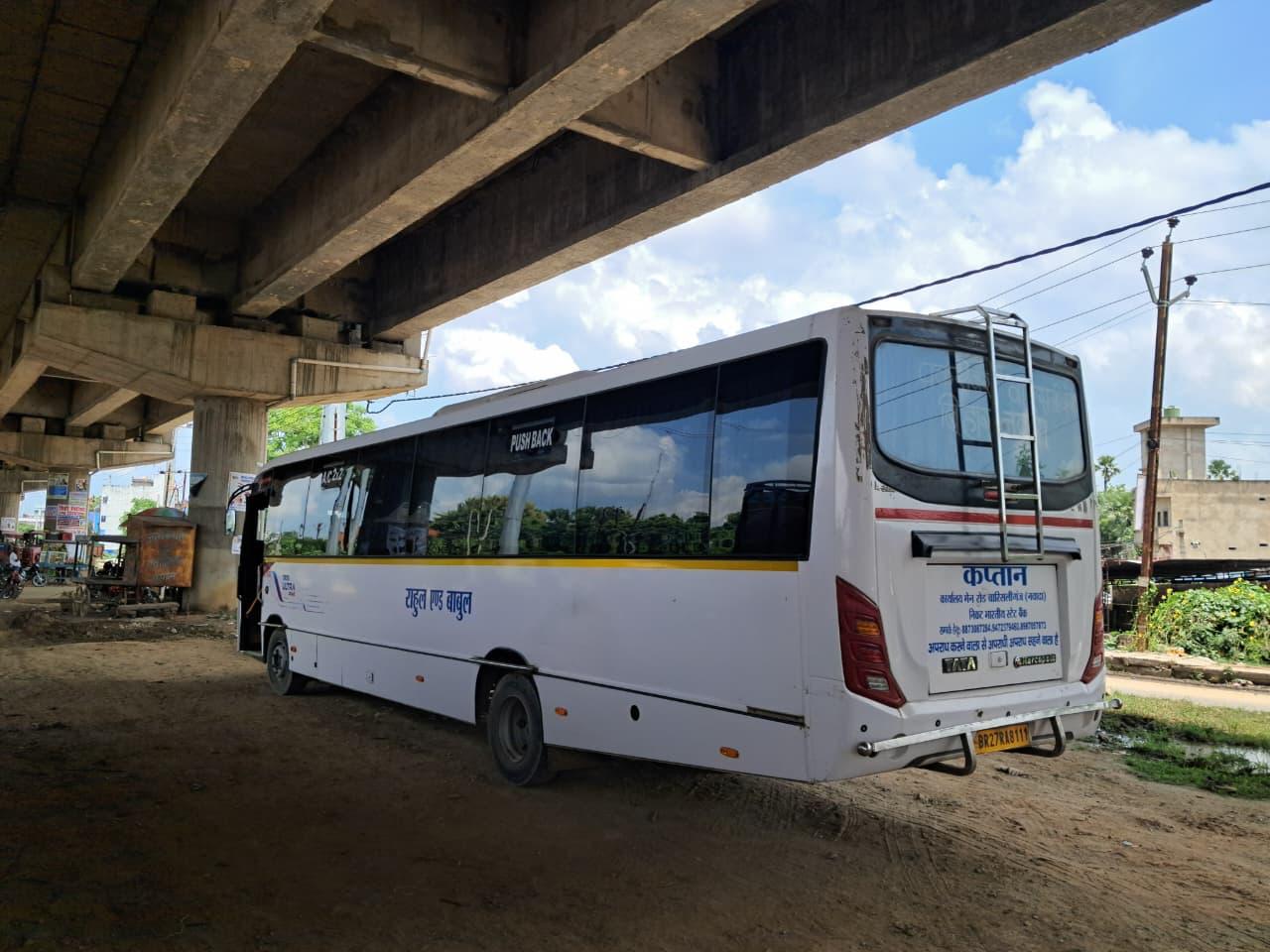 Bus rear angled view under flyover