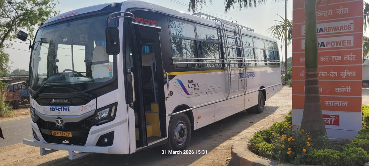 Rahul and Babul Travels bus angled with tree backdrop